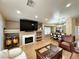 Open-concept living room with fireplace, hardwood floors, recessed lighting, and dining room at 4484 Warbonnet Way, Las Vegas, NV 89147