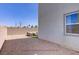 Enclosed backyard with patio furniture, artificial grass, and stone landscaping at 5692 Tinar St, Las Vegas, NV 89113