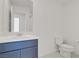 This bathroom features modern fixtures, a blue vanity, and a large mirror at 5692 Tinar St, Las Vegas, NV 89113