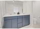 Bright bathroom with a double vanity, a large mirror, and a toilet at 5692 Tinar St, Las Vegas, NV 89113
