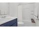 Cozy bathroom with shower/tub combo with white shower curtain and navy vanity at 5692 Tinar St, Las Vegas, NV 89113