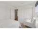 Bright bedroom features neutral tones, a chair, and a closet at 5692 Tinar St, Las Vegas, NV 89113
