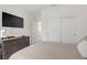 Well-lit bedroom with wall-mounted TV, dresser and closet with sliding doors at 5692 Tinar St, Las Vegas, NV 89113