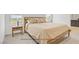 Bedroom showcasing a wooden bed frame and neutral bedding, with modern bedside table at 5692 Tinar St, Las Vegas, NV 89113