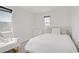Serene bedroom with white bedding, comfortable rocking chair, and a bright window at 5692 Tinar St, Las Vegas, NV 89113