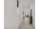 Bright hallway with modern gray console table, light tile floors, and recessed lighting at 5692 Tinar St, Las Vegas, NV 89113