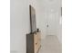 Modern hallway features light tile flooring, gray accent cabinet and recessed lighting at 5692 Tinar St, Las Vegas, NV 89113