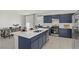 Bright open concept kitchen features an island, stainless steel appliances, and dining area at 5692 Tinar St, Las Vegas, NV 89113