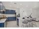 Bright, modern kitchen with blue cabinets, stainless steel appliances, and island seating at 5692 Tinar St, Las Vegas, NV 89113