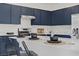 Modern kitchen with blue cabinets, stainless steel appliances, and island seating at 5692 Tinar St, Las Vegas, NV 89113