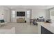 Bright living and dining area adjacent to kitchen features large TV and neutral decor at 5692 Tinar St, Las Vegas, NV 89113