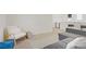 Inviting loft features a gray sofa, white chair, blue ottoman, and desk area at 5692 Tinar St, Las Vegas, NV 89113