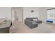 Carpeted loft with sofa, desk, chair and a window for natural light at 5692 Tinar St, Las Vegas, NV 89113