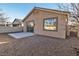 Cozy backyard featuring desert landscaping and patio, with a glimpse of palm trees through the window at 10200 Wood Work Ln, Las Vegas, NV 89135