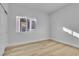 Bright bedroom featuring a large window and neutral-toned floors at 10200 Wood Work Ln, Las Vegas, NV 89135