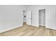 Well-lit bedroom offers wood floors and a closet with sliding doors at 10200 Wood Work Ln, Las Vegas, NV 89135