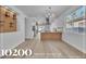 Bright, open kitchen boasts white cabinets, island, and modern light fixtures at 10200 Wood Work Ln, Las Vegas, NV 89135