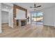 Cozy living room featuring a stone fireplace, wood floors, and sliding glass doors at 10200 Wood Work Ln, Las Vegas, NV 89135