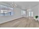Bright living room with wood floors, modern lighting, and large windows at 10200 Wood Work Ln, Las Vegas, NV 89135