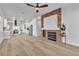 Spacious living room with fireplace, modern lighting, and wood-style floors at 10200 Wood Work Ln, Las Vegas, NV 89135