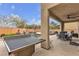 Backyard with a pool, outdoor seating, and ping pong table at 10412 Deer Heights St, Las Vegas, NV 89178