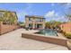 An expansive backyard with a pool, patio, and outdoor seating area invites relaxation and entertaining at 10412 Deer Heights St, Las Vegas, NV 89178