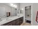 Bathroom featuring a double vanity, modern lighting, and a walk-in shower at 10412 Deer Heights St, Las Vegas, NV 89178