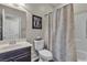 Clean and bright bathroom with a single vanity, framed mirror, and a shower-tub combination with shower curtain at 10412 Deer Heights St, Las Vegas, NV 89178
