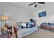 Bedroom featuring a ceiling fan, neutral decor, and a large window at 10412 Deer Heights St, Las Vegas, NV 89178