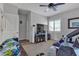 Bright bedroom with carpet, ceiling fan, a TV, and lots of natural light at 10412 Deer Heights St, Las Vegas, NV 89178