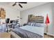 Bedroom with a comfortable bed, ceiling fan and a workstation with computer at 10412 Deer Heights St, Las Vegas, NV 89178