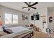 Bedroom with a comfortable bed, ceiling fan, natural light and a wall-mounted TV at 10412 Deer Heights St, Las Vegas, NV 89178