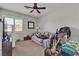 Bedroom featuring a ceiling fan, neutral decor, and a large window at 10412 Deer Heights St, Las Vegas, NV 89178