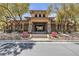 Inviting community clubhouse exterior with stone accents, lush landscaping, and a welcoming entrance at 10412 Deer Heights St, Las Vegas, NV 89178