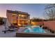 Backyard features a pool, outdoor seating, and a built-in fire pit creating an inviting outdoor living space at 10412 Deer Heights St, Las Vegas, NV 89178