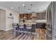 A spacious kitchen featuring a central island with seating, granite countertops, and stainless steel appliances at 10412 Deer Heights St, Las Vegas, NV 89178