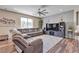 Inviting living room with hardwood floors, a large sectional sofa, and a media center at 10412 Deer Heights St, Las Vegas, NV 89178
