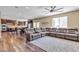 Open-concept living room showcasing hardwood floors and an oversized sofa at 10412 Deer Heights St, Las Vegas, NV 89178