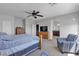 Main bedroom showcasing plush carpet, a ceiling fan, and an ensuite bathroom at 10412 Deer Heights St, Las Vegas, NV 89178