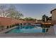 Inviting pool and spa area features a built-in fire pit, elegant water features, and privacy landscaping at 10412 Deer Heights St, Las Vegas, NV 89178
