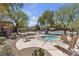 Relaxing pool area with lounge chairs, spa, mature trees, and beautiful landscaping at 10412 Deer Heights St, Las Vegas, NV 89178