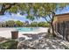 Exterior shot of the community pool, featuring shade trees and lounge areas at 10412 Deer Heights St, Las Vegas, NV 89178
