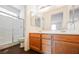 Bathroom with double sink vanity, wood cabinets, and glass enclosed shower at 10505 Jeremy Ridge Ave, Las Vegas, NV 89144