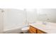 Full white bathroom with bathtub, shower and wood vanity at 10505 Jeremy Ridge Ave, Las Vegas, NV 89144