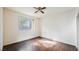 Bedroom featuring wood floors, a ceiling fan, and a large window at 10505 Jeremy Ridge Ave, Las Vegas, NV 89144