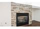Living room fireplace with stacked stone surround and a glass front at 10505 Jeremy Ridge Ave, Las Vegas, NV 89144