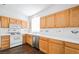 Kitchen featuring wood cabinets, white countertops, and stainless steel dishwasher at 10505 Jeremy Ridge Ave, Las Vegas, NV 89144