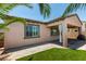 Backyard featuring a covered patio, well-manicured grass area, and decorative palm trees at 1128 Via Della Curia, Henderson, NV 89011