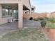 Inviting backyard with covered patio, manicured lawn, and desert landscaping offers a private outdoor space at 1128 Via Della Curia, Henderson, NV 89011