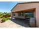 Spacious backyard featuring a covered patio, lush landscaping, and brick pavers at 1128 Via Della Curia, Henderson, NV 89011